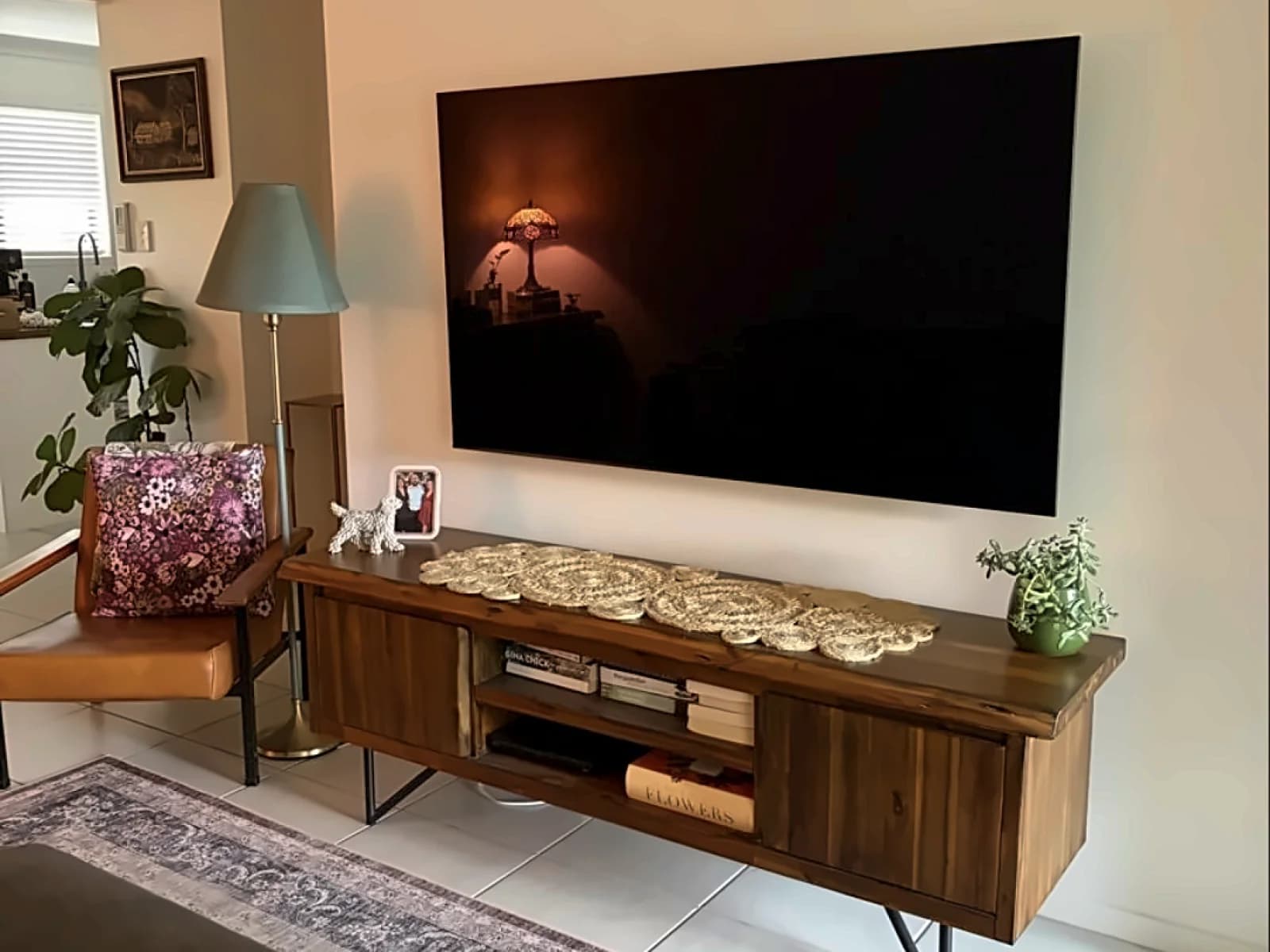 A finished Mr Install job: TV floating flush on a lounge-room wall, no visible cables